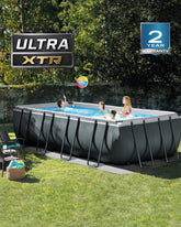 Children playing in a rectangular above-ground pool with 'Ultra XTR' branding and a two-year warranty badge.